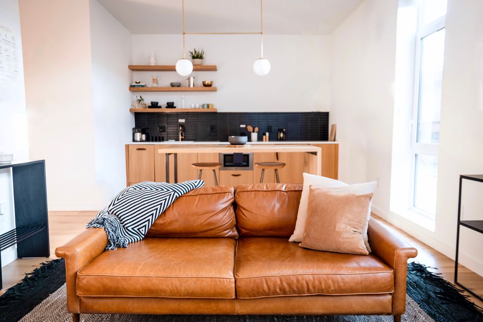 Modern minimalist kitchen and living area with stylish decor in Philadelphia apartment.